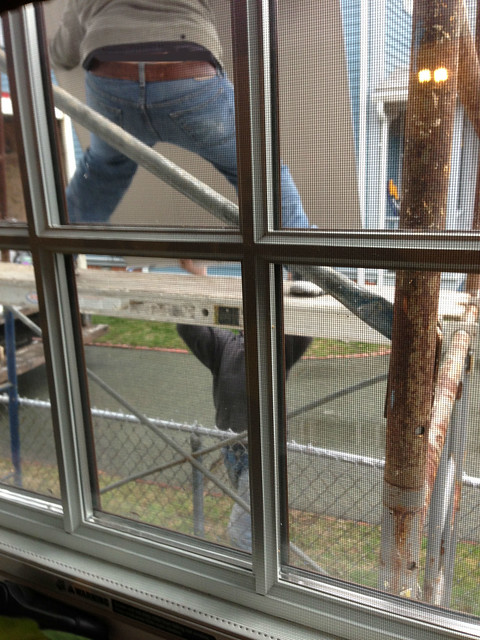 hoisting drywall up scaffolding